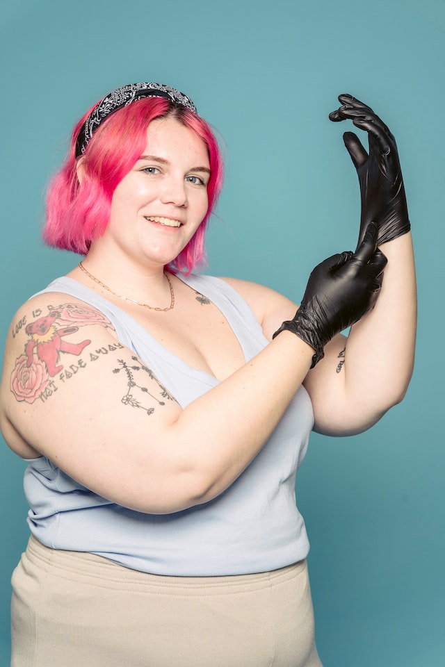 A person happily puts on latex gloves